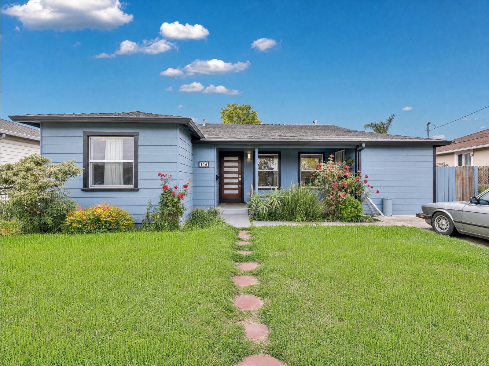 Fully renovated light-blue bungalow with fresh landscaping in Oakland by Four Piers