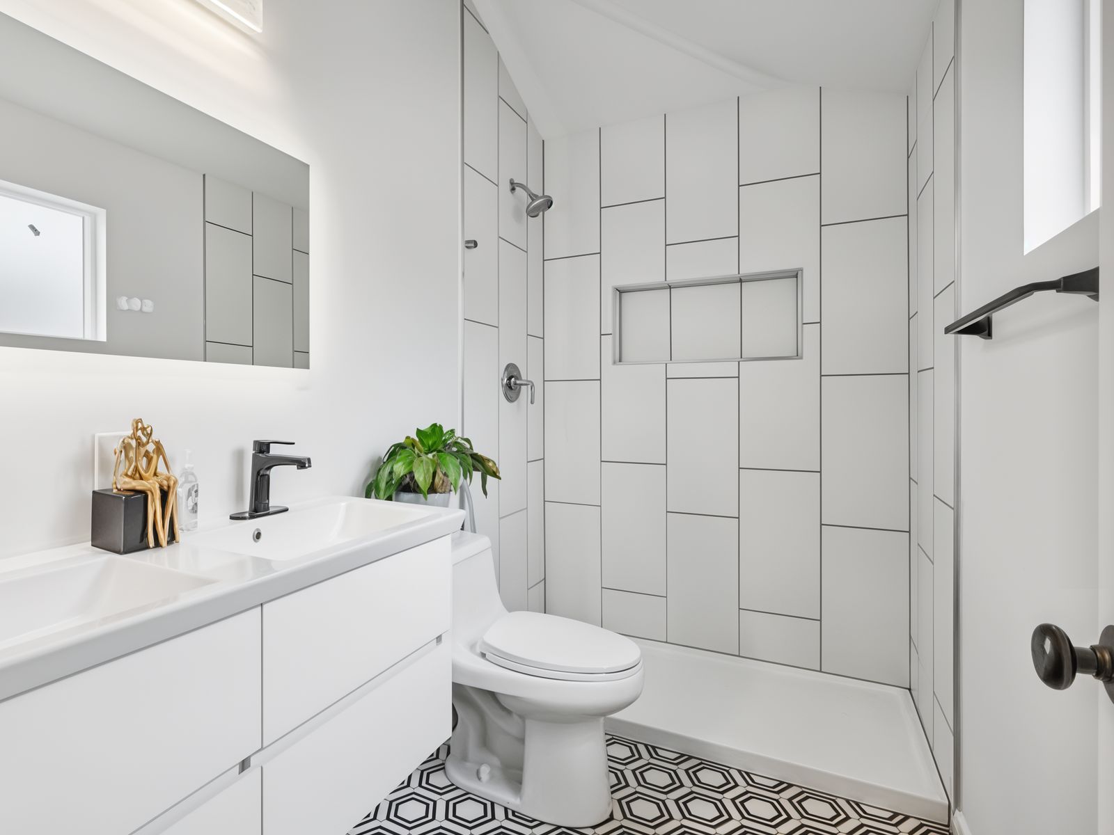 Modern white bathroom remodel with tiled walk-in shower in Oakland by Four Piers