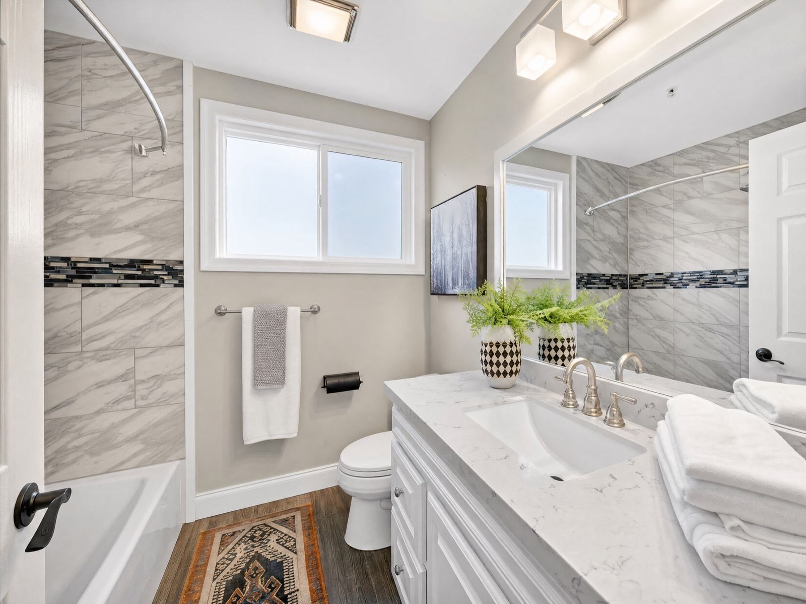 Marble-tile bathroom remodel in Sacramento by Four Piers